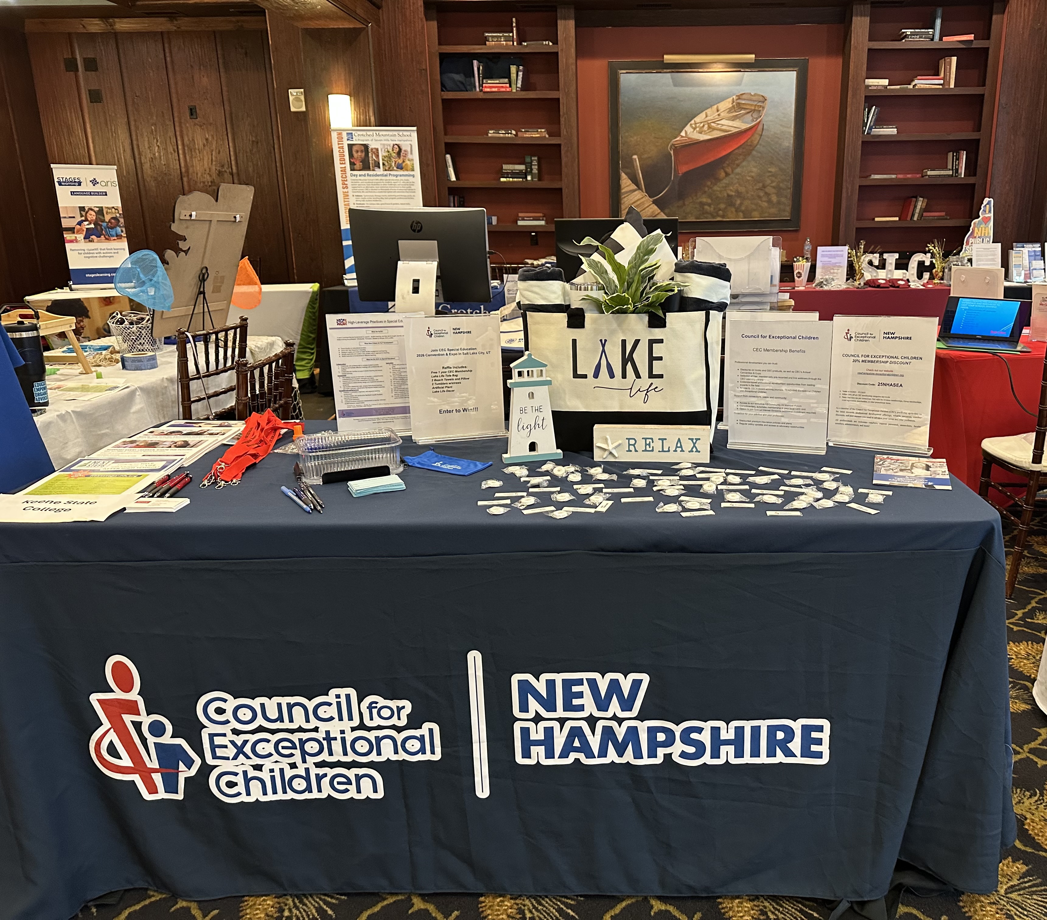 photo of a CEC New Hampshire booth at an event with many giveaways presented on the table